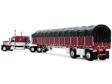 Peterbilt 389 with 63" Flat Top Sleeper and 53’ Wilson Roadbrute Flatbed Trailer with Covered Wagon Maroon with White Stripes 1/64 Diecast Model by DCP/First Gear